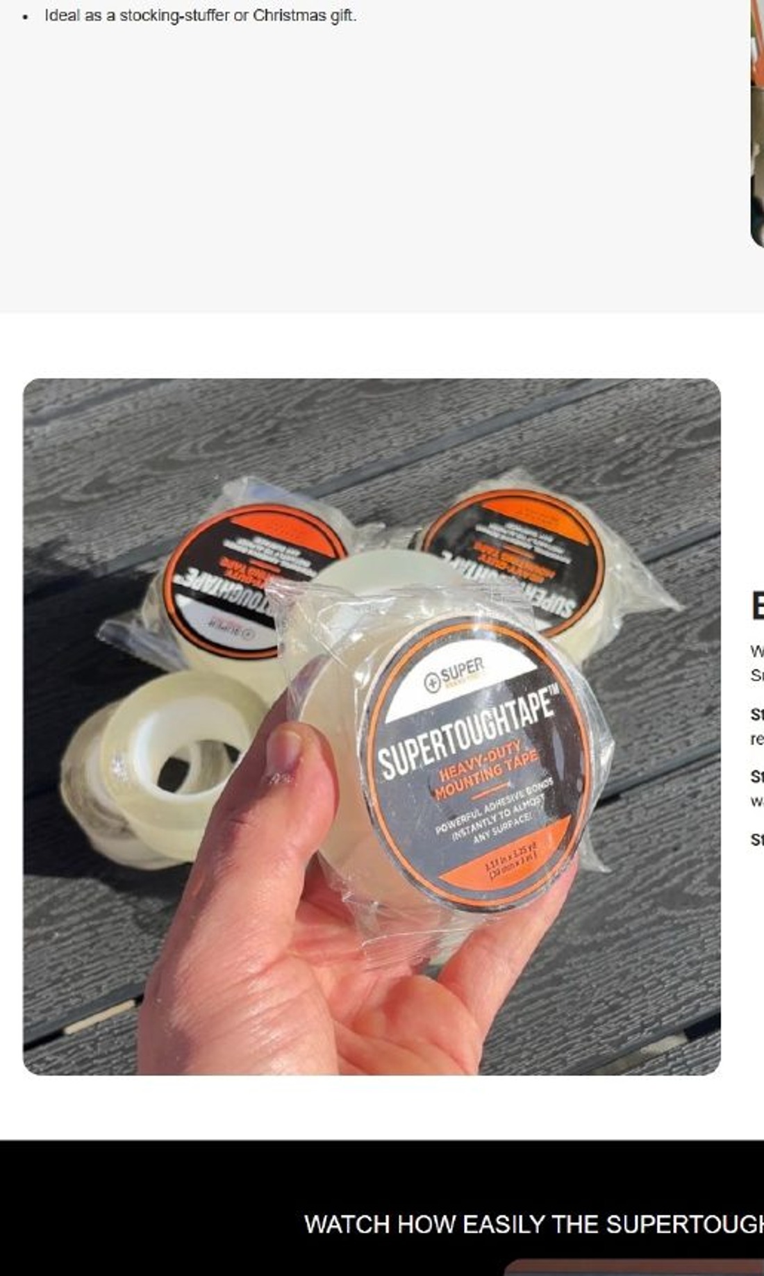 A hand holding a packaged roll of SuperToughTape